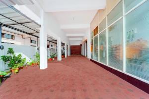 an empty corridor of a building with plants at Super Collection O Chalai Bazaar Near Railway Station Formerly Galaxy Inn in Trivandrum +44 photos