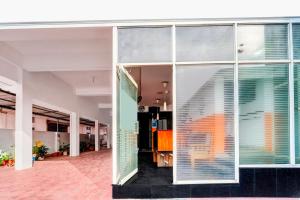 a hallway of a building with large windows at Super Collection O Chalai Bazaar Near Railway Station Formerly Galaxy Inn in Trivandrum