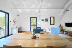 a living room with a large wooden table and chairs at Loft Ôrizon - Domaine De L'ô in Bellacaud