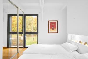 a white bedroom with two beds and a window at Loft Ôrizon - Domaine De L'ô in Bellacaud +22 photos
