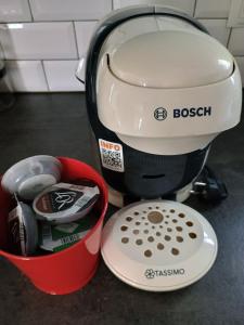 a mixer sitting next to a red bucket at Maison de Village au pied des montagnes in Randens