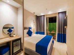 a hotel room with a bed and a mirror at Echinus Blue Hotel in Antalya +52 photos