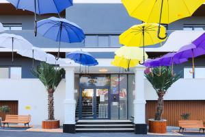 a group of umbrellas hanging in front of a building at Adler Apartments in Prizren