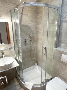 a bathroom with a shower and a toilet and a sink at Rooms Lidija in Zagreb +56 photos