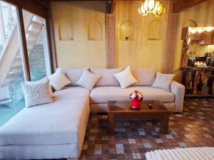 a living room with a couch and a coffee table at Rooftop terasse azur essaouira in Essaouira