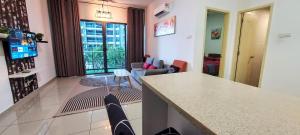 a kitchen and living room with a counter and chairs at Rich Return Empire in Gua Sai