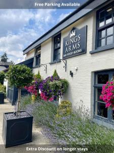 a building with flowers on the side of it at The Kings Arms in Coggeshall