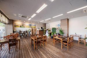 a room with tables and chairs in a store at Hotel Kasuien in Ureshino