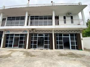 a large building with large windows and a balcony at BMC HomeStay in Sebungsungai
