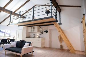 ein Loft mit einer Treppe und einem Wohnzimmer in der Unterkunft Horse Whispering Ranch apartma in Ilirska Bistrica