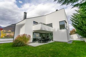 a white house with a green yard at Villa Shangrila - Alpstay in Naturno