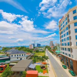 a city street with buildings and a blue sky at Kingdom Hotel Cua Lo in Cửa Lò