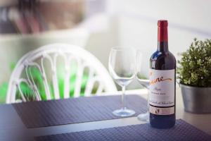 een fles wijn en twee glazen op een tafel bij Los cristianos Vistas al mar y cerca de la playa in Los Cristianos