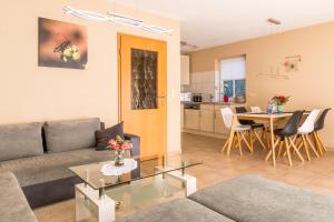 a living room with a couch and a table at Jagdhaus Prerowstrom in Jagdhaus