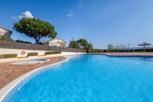a large swimming pool with blue water at Host Dalies in San Pedro de Premiá