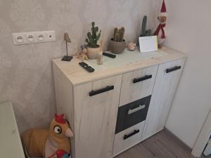 a wooden cabinet with plants on top of it at Tallinna mnt 15 Apartament in Narva +2 photos