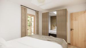 a bedroom with a white bed and a mirror at Alpen Lodge Kirchberg in Kirchberg in Tirol