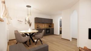 a kitchen and dining room with a table and chairs at Alpen Lodge Kirchberg in Kirchberg in Tirol