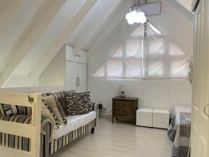 a living room with a couch and a bed and a ceiling at Karlin #2, Frontline, Beach Access, Scottburgh in Freeland Park