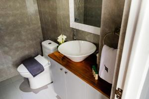 a small bathroom with a sink and a toilet at Hotel Bijoux in Plaridel