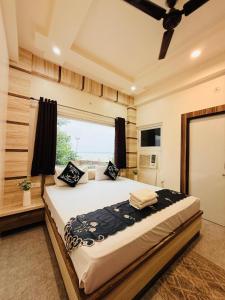 um quarto com uma cama grande com janela em Rudra Ganga Atithi Hotel em Varanasi