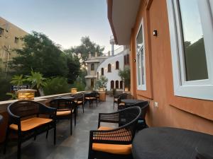 a row of tables and chairs on a patio at Aurum Pyramids in Cairo