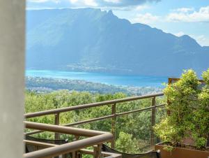 a view of a mountain and a lake from a balcony at Logis Hôtel Le Bellevue in Trévignin