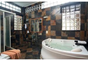 a large bathroom with a tub and a shower at The Nai Harn Collective in Rawai Beach +92 photos