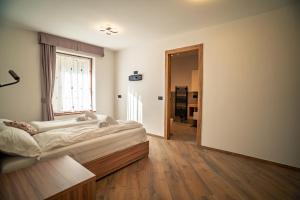 Ένα ή περισσότερα κρεβάτια σε δωμάτιο στο La Stua de Anny