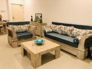 a living room with two couches and a coffee table at Fairway Galle in Galle