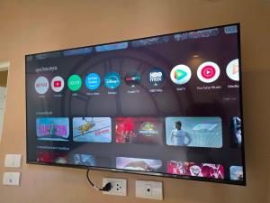 a large flat screen tv hanging on a wall at Terminal58hostel@town in Ban Lo Long