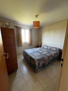 a bedroom with a bed and a window at Cabañas Las Primorosas in Cañuelas +57 photos