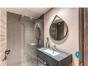 a bathroom with a sink and a mirror at Triplyrooms Collection - Parioli in Rome