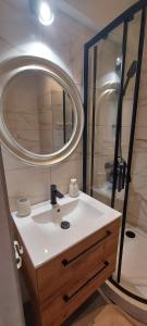 a bathroom with a white sink and a mirror at Anna's centrum apt in Artemida