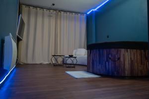 a room with a room with a couch and a table at Loveroom Metz Centre Private Spa in Metz