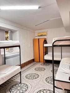 a dorm room with three bunk beds in it at Adeke hostel in Atyraū