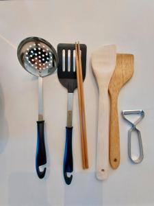 a group of wooden utensils hanging on a wall at 一棟貸民泊西戸崎駅前 in Fukuoka