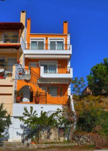 an orange and white building on a hill at Summer House Nea Peramos in Néa Péramos