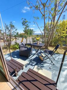 a patio with a table and chairs and a table at 一棟貸民泊西戸崎駅前 in Fukuoka