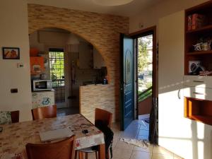a kitchen and dining room with a table and a door at Travel Solution - Seaview & Roman Apartments in Anzio