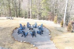 a group of chairs sitting around a fire pit at Karaoke Hot Tub 1GB WiFi - The Rock House - LUX in Rogers