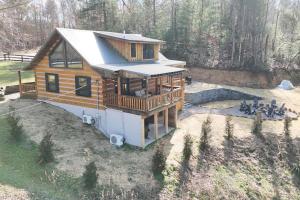 an aerial view of a cabin in the woods at Karaoke Hot Tub 1GB WiFi - The Rock House - LUX in Rogers