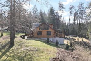 a log cabin on a hill in the woods at Karaoke Hot Tub 1GB WiFi - The Rock House - LUX in Rogers +45 photos