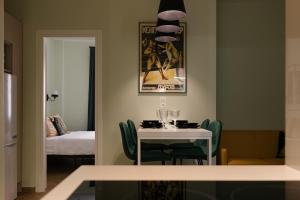 a dining room with a table and a bed at 2 BR Apartment with Sitcom Vibes VIPGreece in Athens