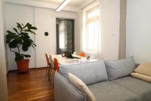 a living room with a couch and a table with a laptop at Lavanttalbahn Suite in Bad Sankt Leonhard im Lavanttal