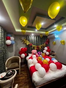 a room with a large bed with balloons on it at Hotel BnB Mhepi in Kathmandu