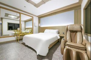 Ένα ή περισσότερα κρεβάτια σε δωμάτιο στο Jeonju Eldorado