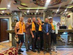 a group of men wearing yellow ties posing for a picture at Hotel BnB Mhepi in Kathmandu