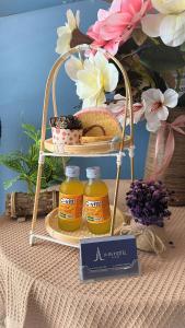 a basket of honey and bread on a table with flowers at A In Hotel Glamour in Ho Chi Minh City