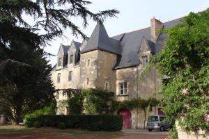 an old house with a van parked in front of it at Troglo De Denise in Civray-de-Touraine